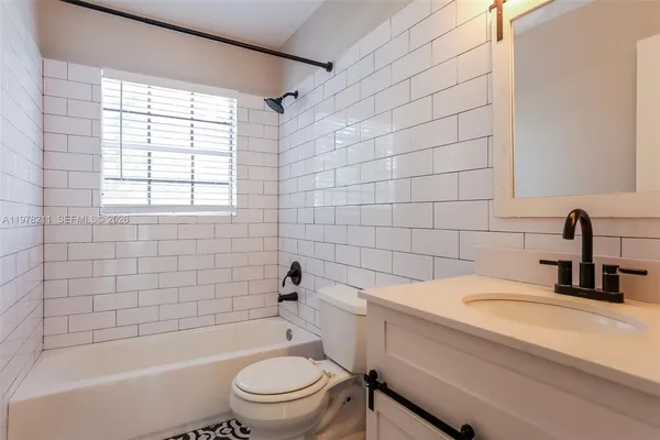 a bathroom with a sink a toilet and a bathtub