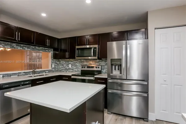a kitchen with a refrigerator and a sink