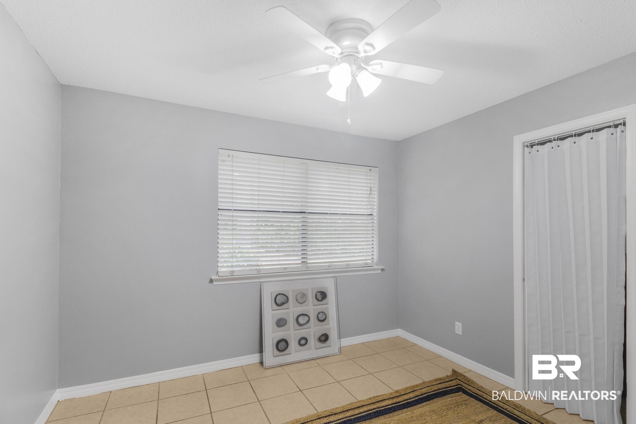 110 5th Street, Unit A 103 Daphne, AL 36526 - Photo 20 of 28 Spare room featuring ceiling fan and light tile patterned flooring