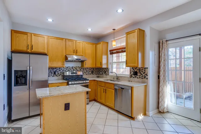 a spacious bathroom with a granite countertop sink and a mirror