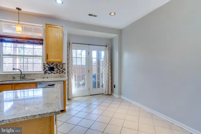 a kitchen with stainless steel appliances a stove a sink and a refrigerator