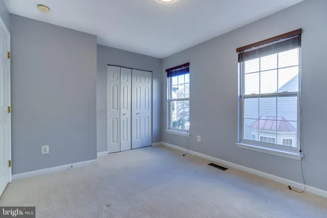 a view of an empty room and closet area