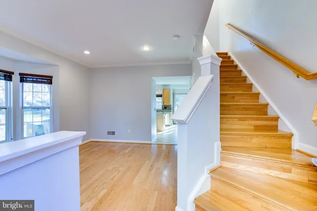 a view of entryway and hall with wooden floor
