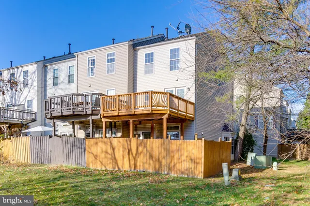 a backyard of a house with barbeque oven and glass windows