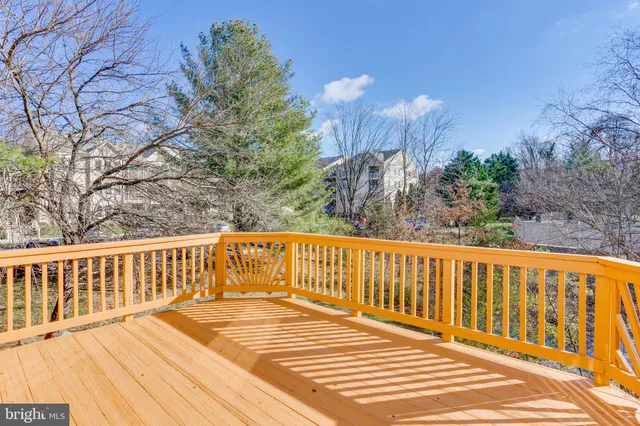a front view of house with yard and trees in the background