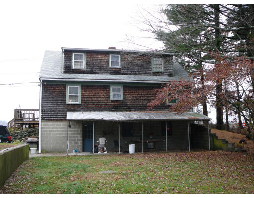 75 Holmes Street Halifax, MA 02338 - Photo 22 of 29 a view of a brick house with a large windows and a large tree