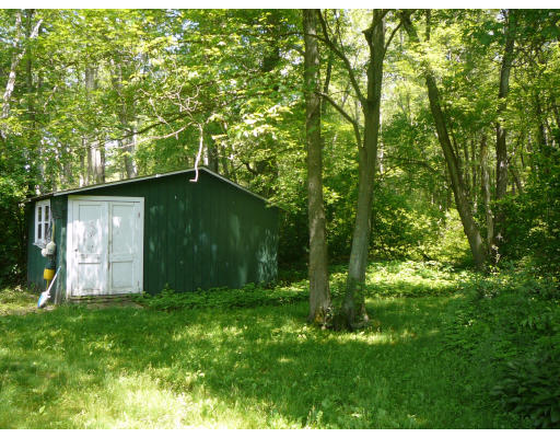 75 Holmes Street Halifax, MA 02338 - Photo 29 of 29 a backyard of a house with lots of green space