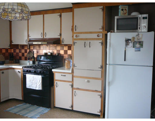 75 Holmes Street Halifax, MA 02338 - Photo 8 of 29 a kitchen with stainless steel appliances white cabinets and a refrigerator