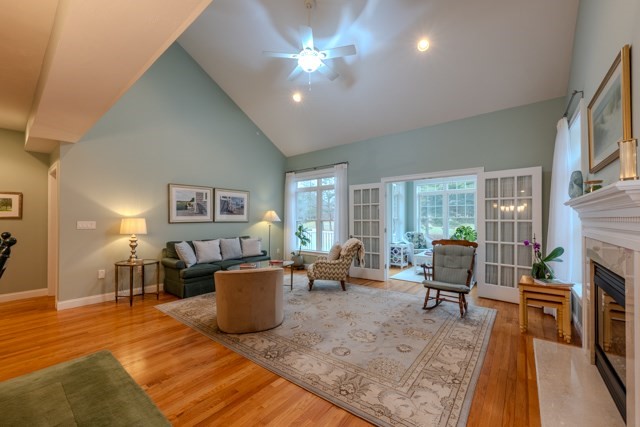 16 Fairway Drive, Unit 16 Topsfield, MA 01983 - Photo 14 of 31 a living room with furniture a fireplace and a table
