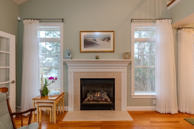16 Fairway Drive, Unit 16 Topsfield, MA 01983 - Photo 15 of 31 a living room with furniture a fireplace and a window