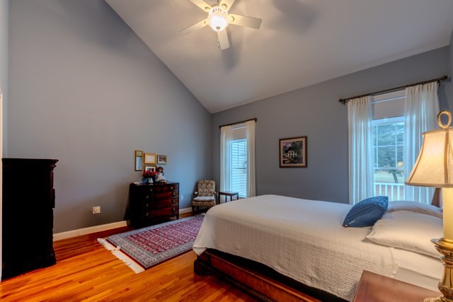 16 Fairway Drive, Unit 16 Topsfield, MA 01983 - Photo 19 of 31 a bedroom with a bed and a chandelier