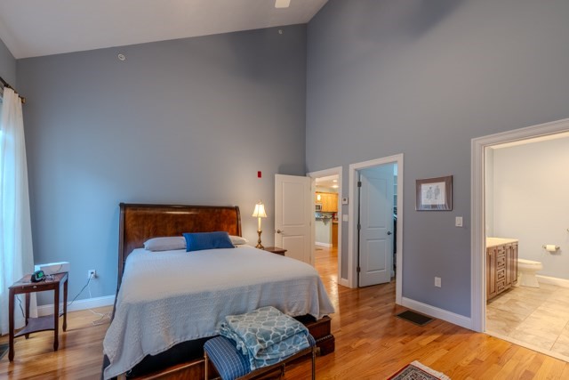 16 Fairway Drive, Unit 16 Topsfield, MA 01983 - Photo 20 of 31 a bedroom with a bed and wooden floor