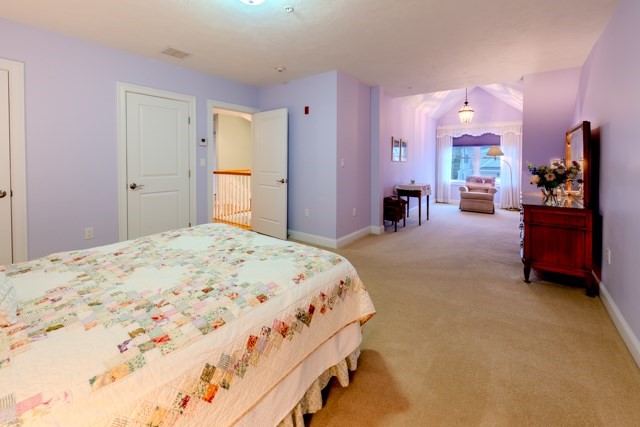 16 Fairway Drive, Unit 16 Topsfield, MA 01983 - Photo 29 of 31 a bedroom with a bed and a large mirror on dresser