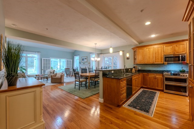 16 Fairway Drive, Unit 16 Topsfield, MA 01983 - Photo 9 of 31 a kitchen with stainless steel appliances granite countertop a stove and a view of living room