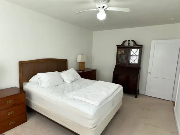 a large white bed in a white room