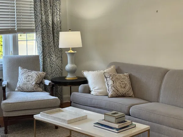a living room with furniture and a lamp