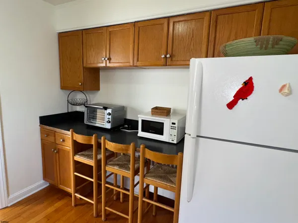 a kitchen with a refrigerator and cabinets