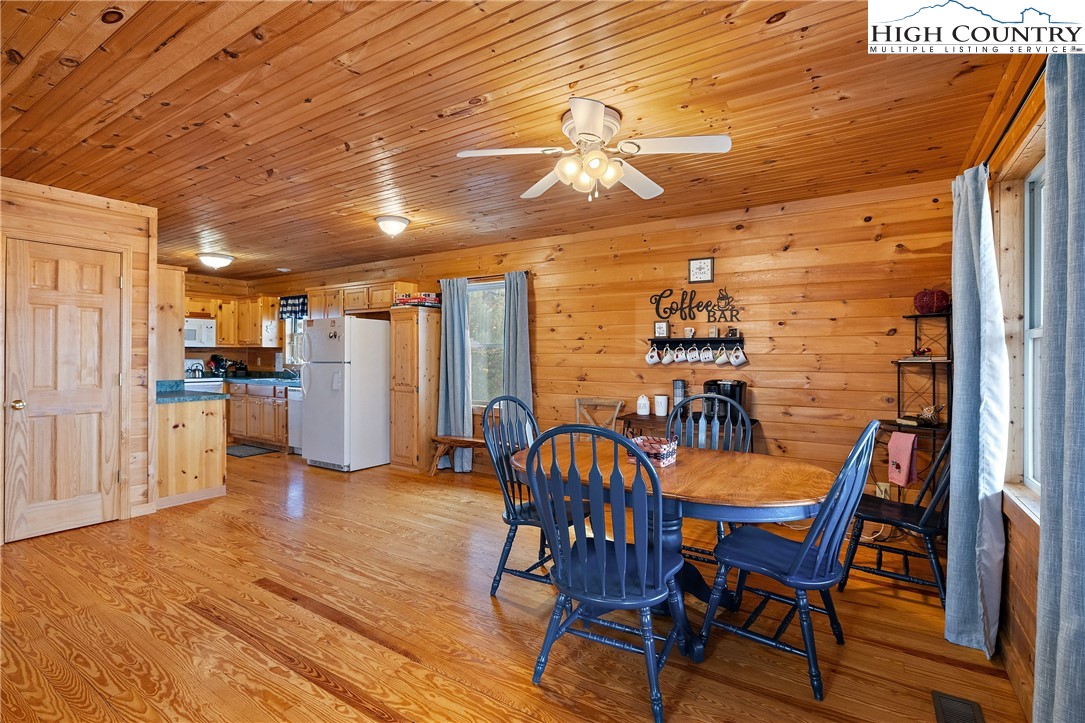 2935 Buck Mountain Road Purlear, NC 28665 - Photo 16 of 49 a view of a dining room with furniture and wooden floor