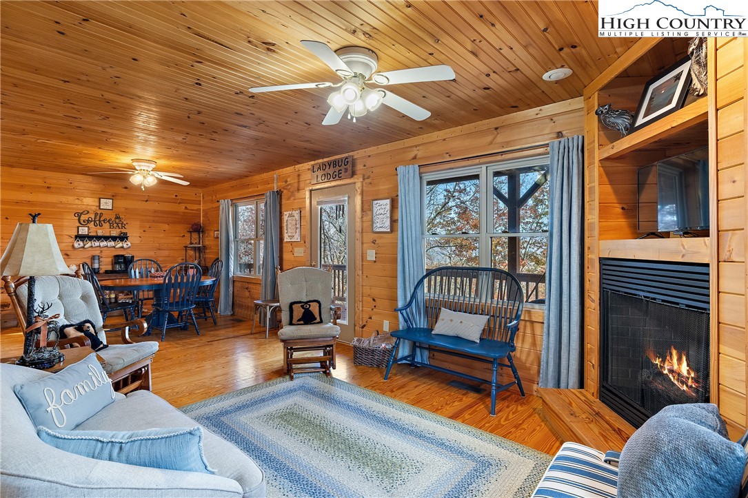 2935 Buck Mountain Road Purlear, NC 28665 - Photo 26 of 49 a living room with furniture a chandelier and a dining table