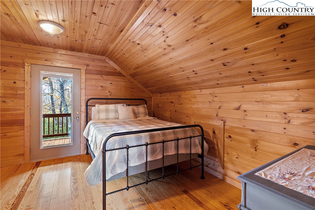 2935 Buck Mountain Road Purlear, NC 28665 - Photo 32 of 49 a bedroom with a bed and wooden floor