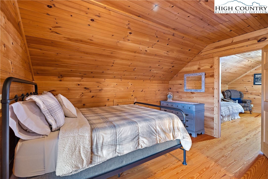 2935 Buck Mountain Road Purlear, NC 28665 - Photo 35 of 49 a bedroom with a bed and wooden floor