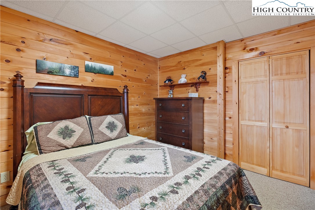 2935 Buck Mountain Road Purlear, NC 28665 - Photo 41 of 49 a bedroom with a bed and a dresser