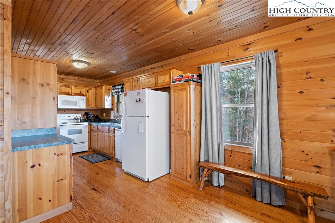 2935 Buck Mountain Road Purlear, NC 28665 - Photo 6 of 49 a view of a kitchen with refrigerator and wooden floor