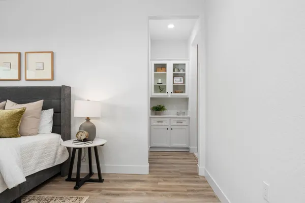 a spacious bathroom with a double vanity sink a large mirror a shower and bathtub