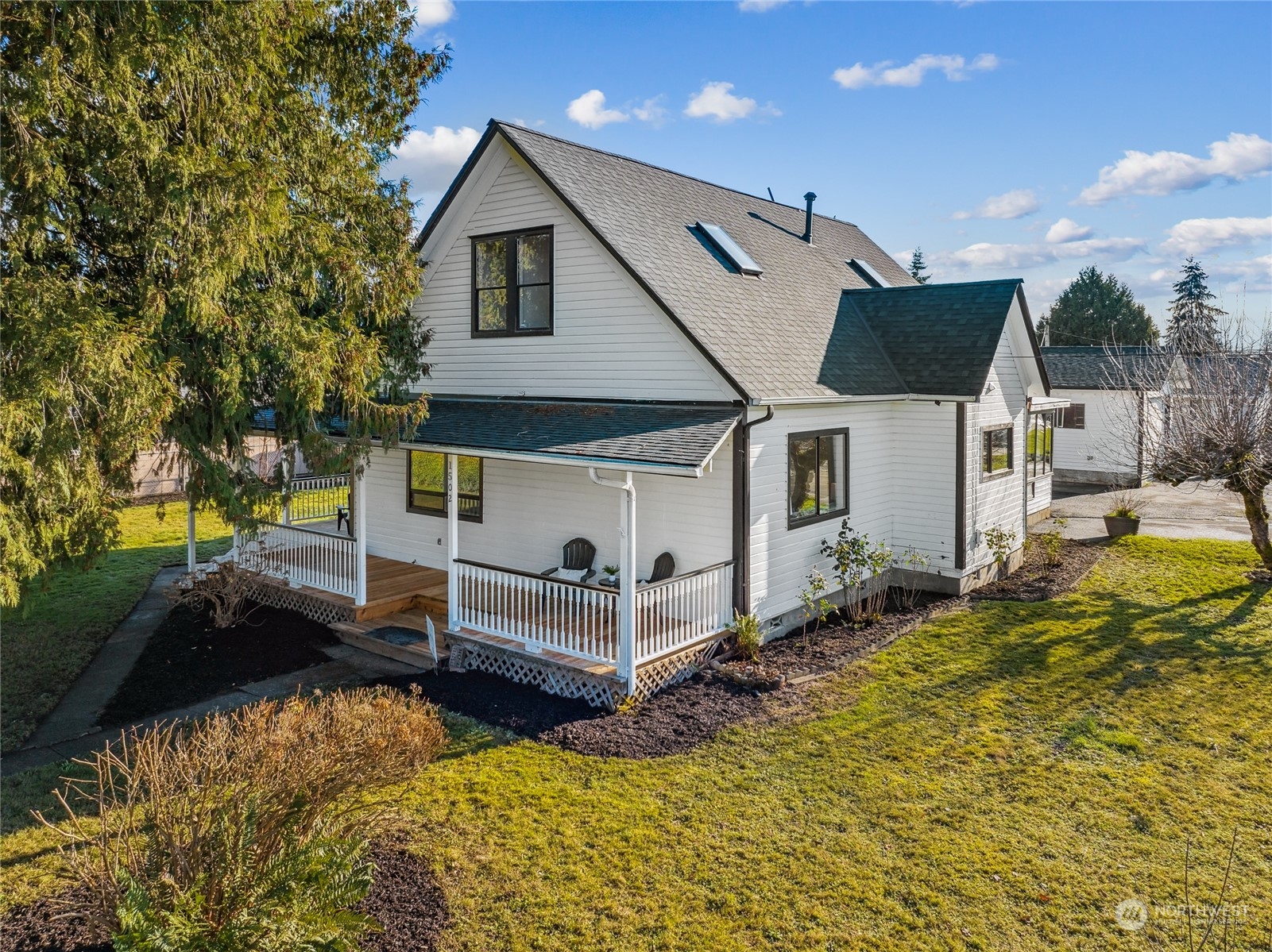 1502 16th Street Sumner, WA 98390 - Photo 1 of 26 a front view of a house with a yard