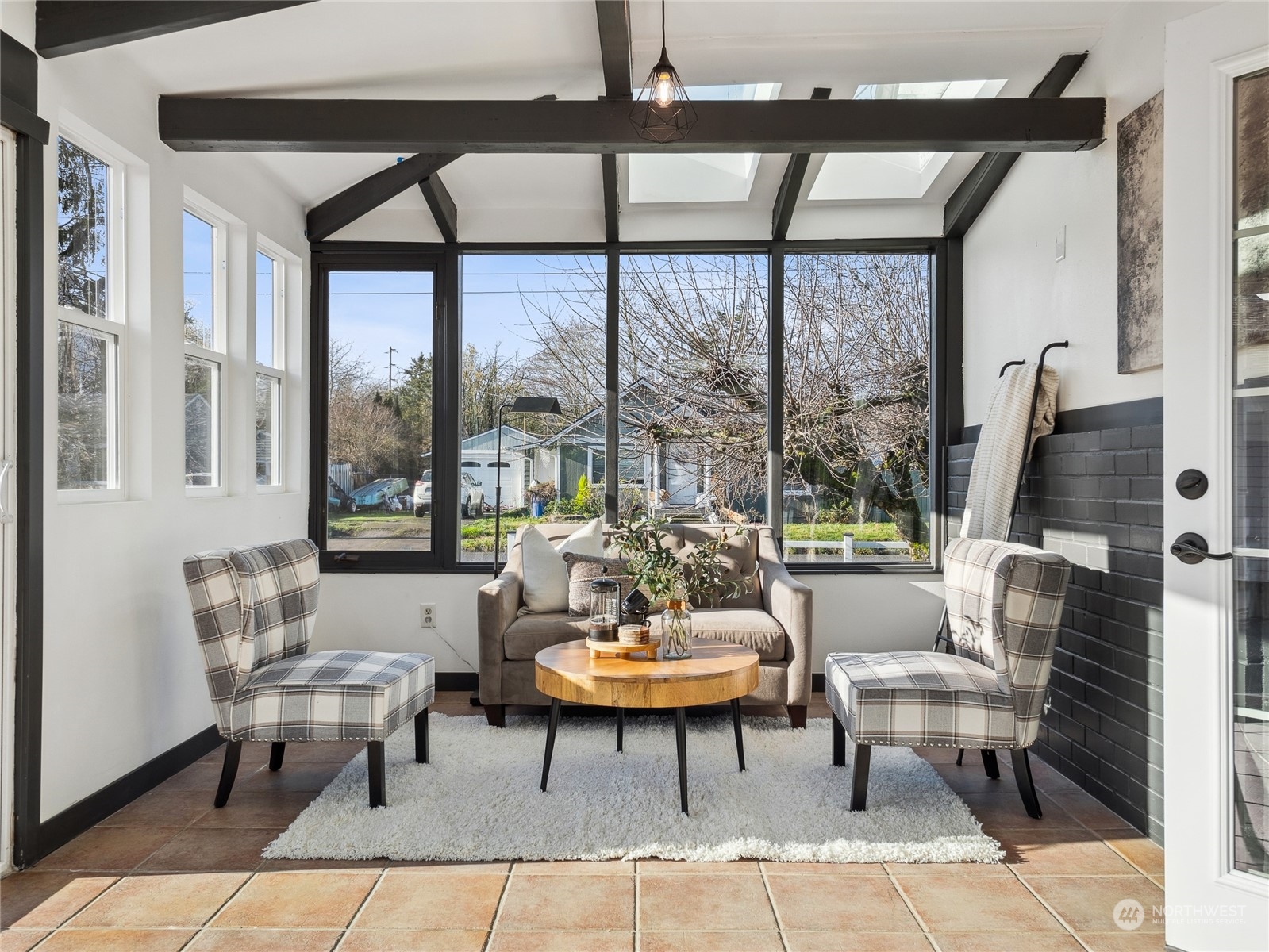 1502 16th Street Sumner, WA 98390 - Photo 13 of 26 a living room with furniture and a floor to ceiling window