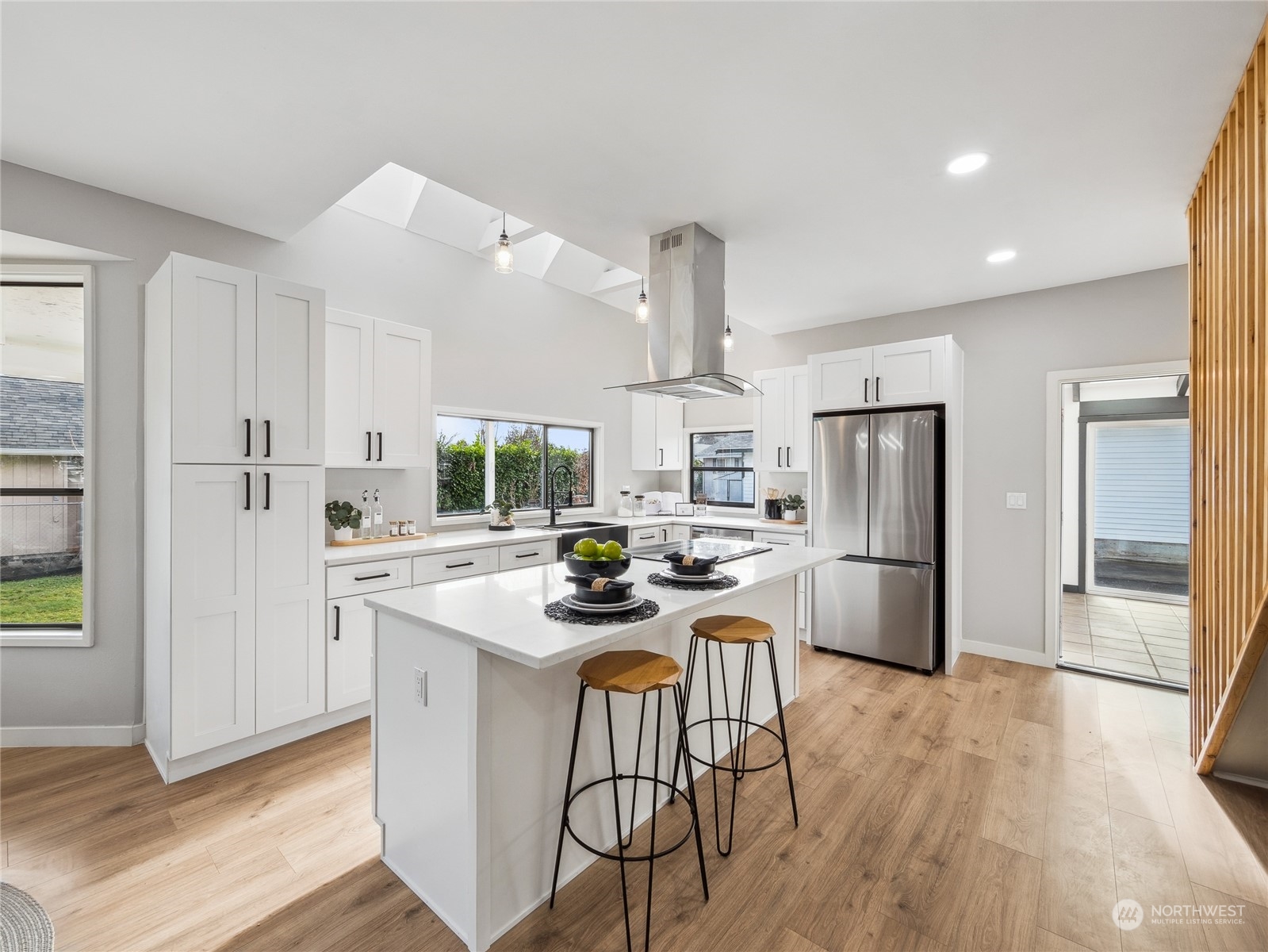 1502 16th Street Sumner, WA 98390 - Photo 9 of 26 a kitchen with refrigerator a stove a sink dishwasher and white refrigerator with wooden floor