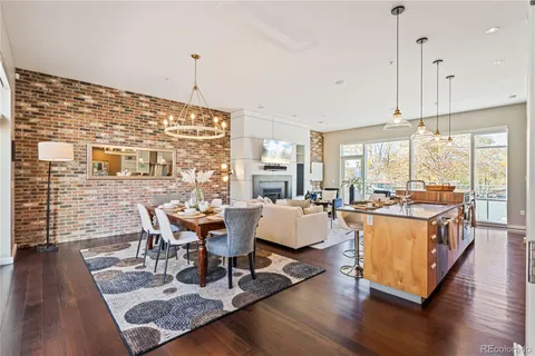a living room with fireplace furniture wooden floor and a table