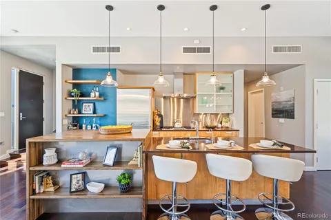 a kitchen with stainless steel appliances granite countertop a stove a sink and a refrigerator