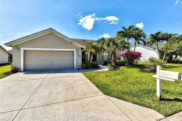 a front view of a house with a yard and a garage