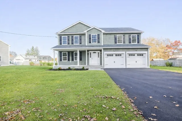 a view of a big house with a big yard and large trees