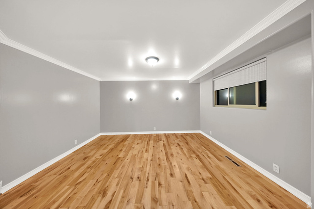 374 West Lakeview Road Lindon, UT 84042 - Photo 13 of 44 Spacious room featuring wood-finish flooring, light grey walls, and white crown molding