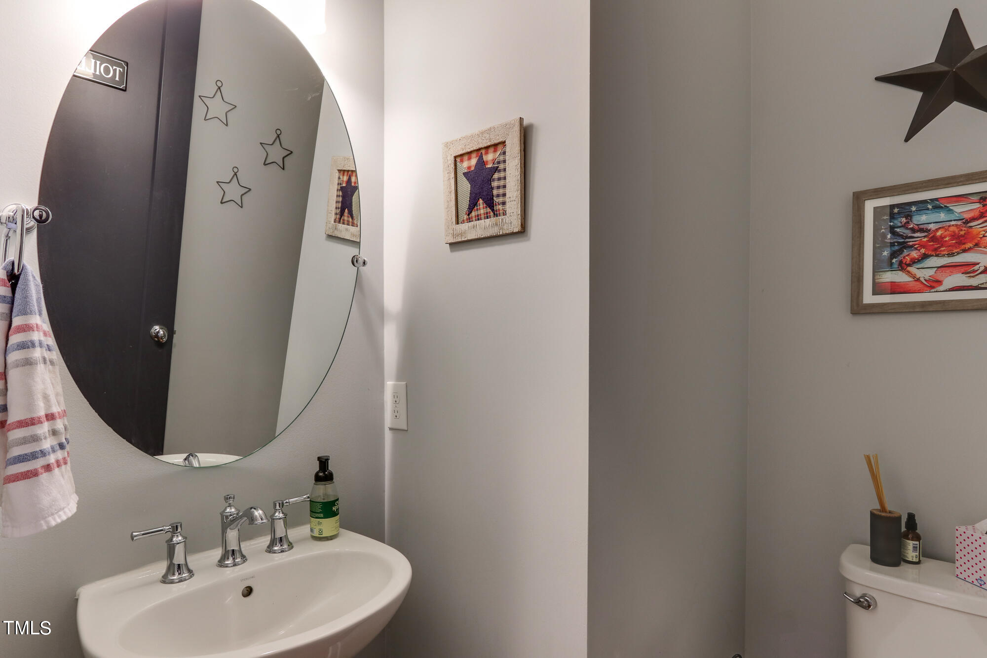 904 Wake Towne Drive Raleigh, NC 27609 - Photo 12 of 30 a bathroom with a sink and mirror with toilet