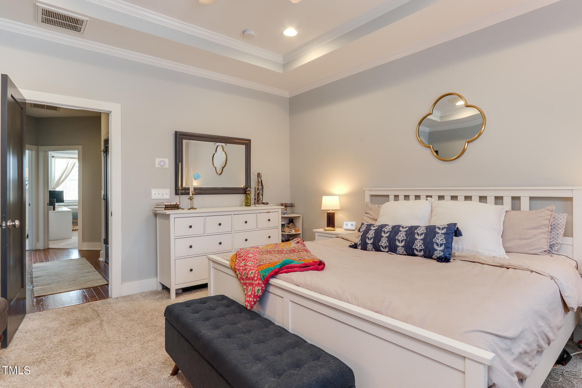 904 Wake Towne Drive Raleigh, NC 27609 - Photo 15 of 30 a bedroom with a bed and a chandelier