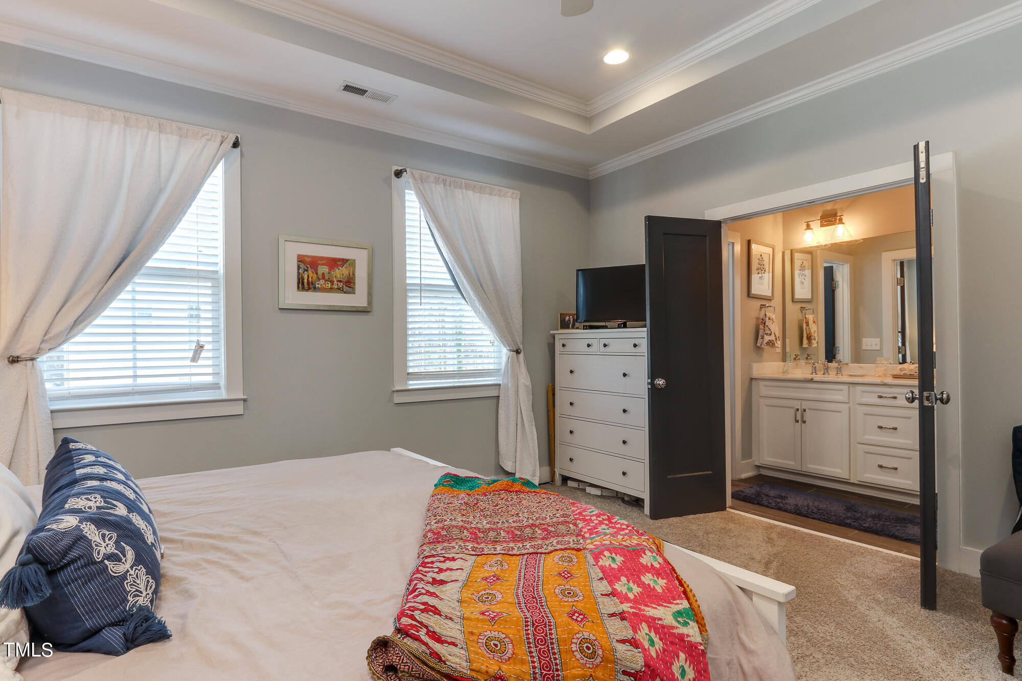 904 Wake Towne Drive Raleigh, NC 27609 - Photo 17 of 30 a bedroom with a bed and a dresser