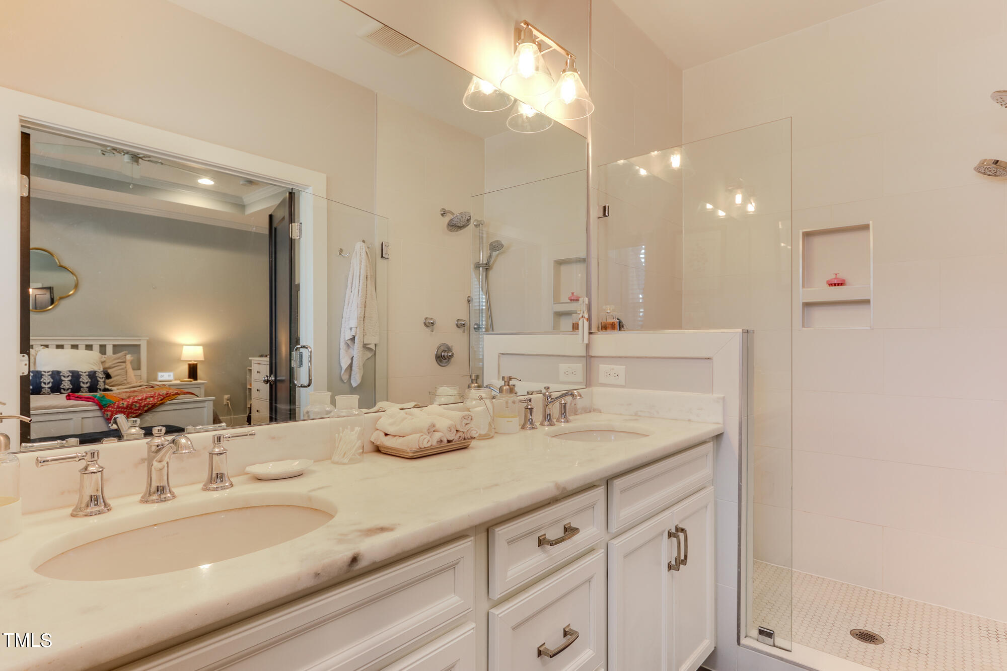 904 Wake Towne Drive Raleigh, NC 27609 - Photo 18 of 30 a bathroom with a double vanity sink and a mirror