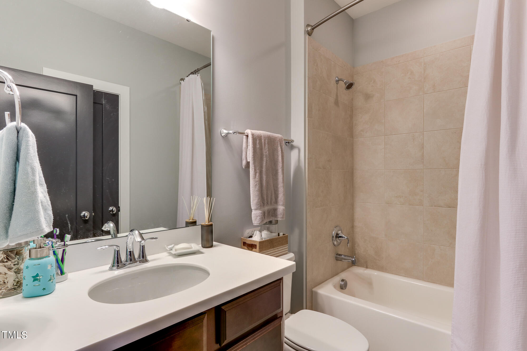 904 Wake Towne Drive Raleigh, NC 27609 - Photo 21 of 30 a bathroom with a bathtub shower sink and toilet