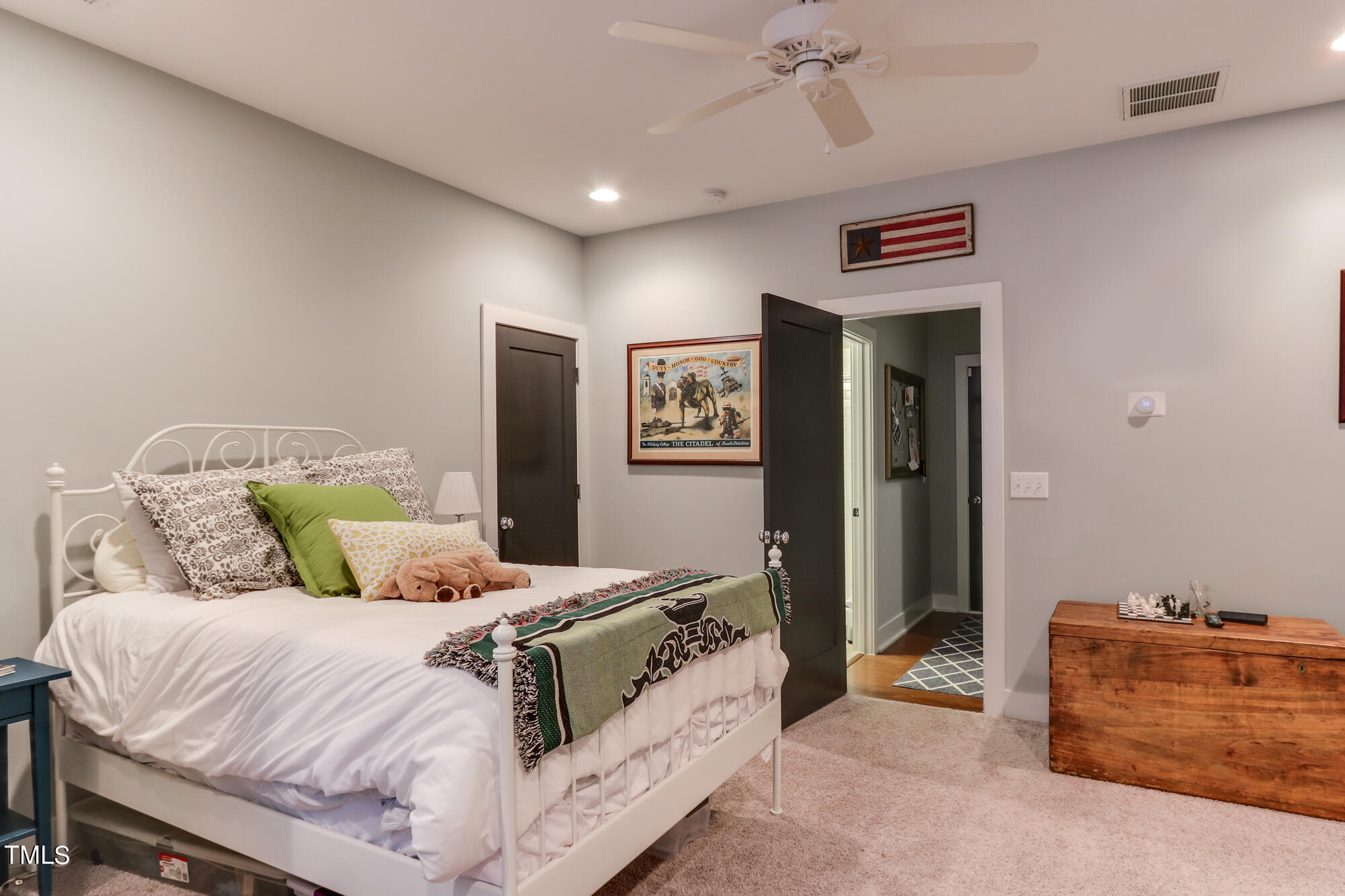 904 Wake Towne Drive Raleigh, NC 27609 - Photo 25 of 30 a bedroom with a bed and a couch