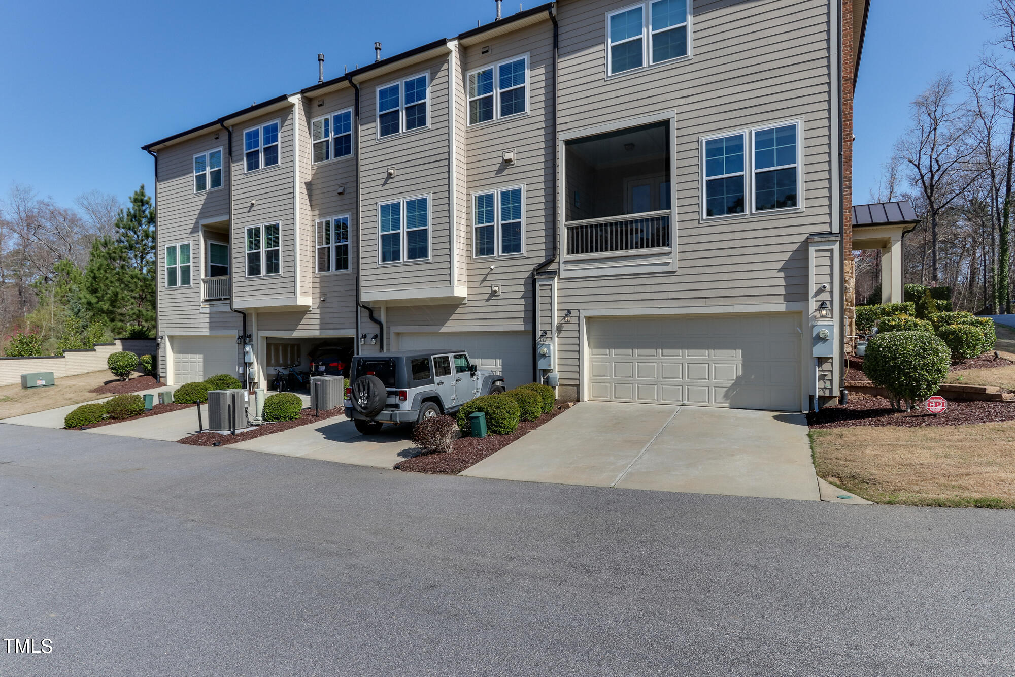 904 Wake Towne Drive Raleigh, NC 27609 - Photo 28 of 30 a view of a brick building with many windows next to a road