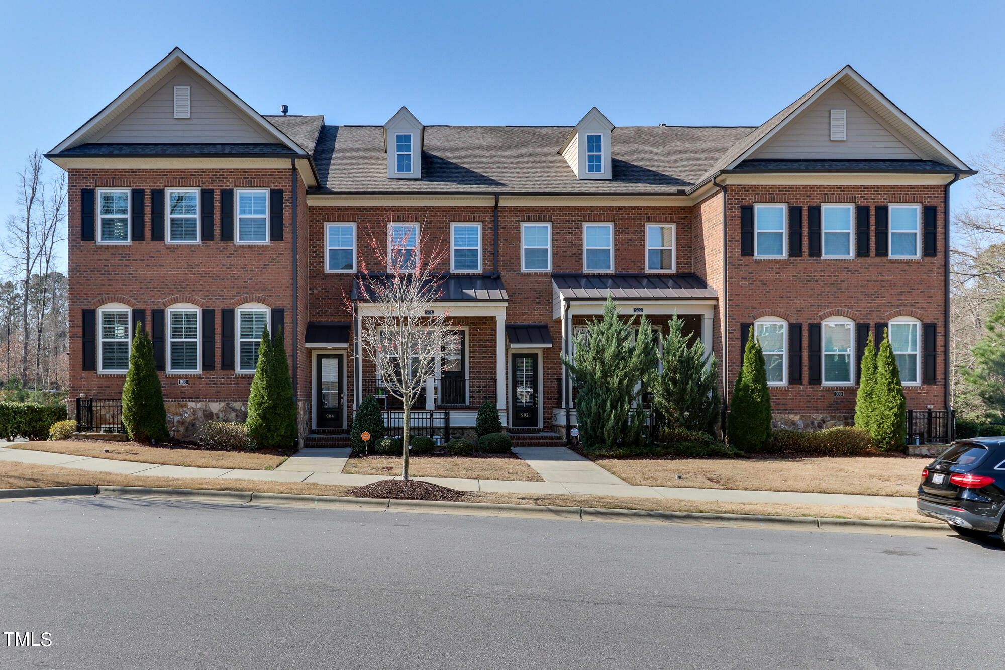 904 Wake Towne Drive Raleigh, NC 27609 - Photo 29 of 30 front view of a brick house next to a yard