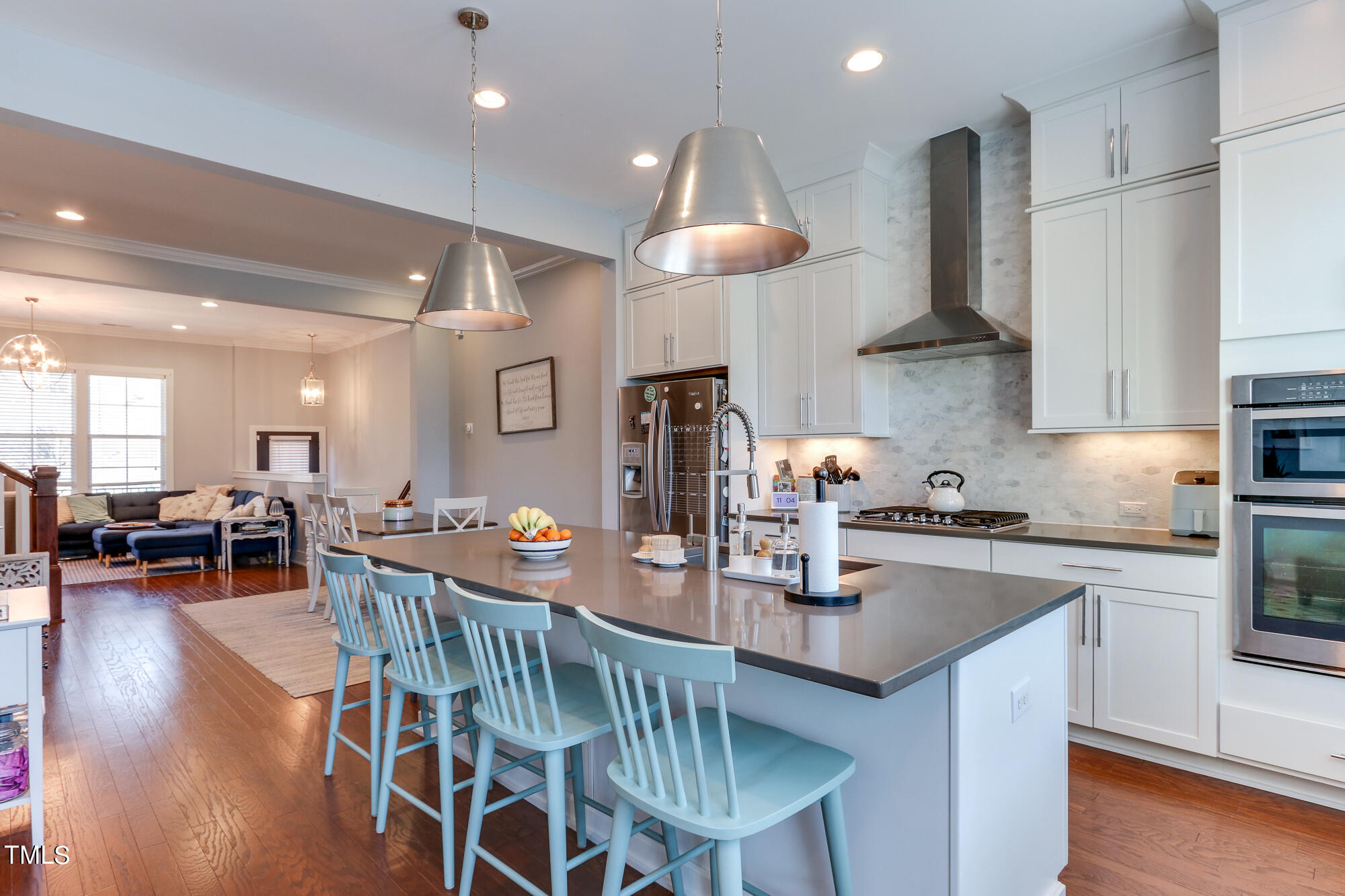 904 Wake Towne Drive Raleigh, NC 27609 - Photo 8 of 30 a kitchen with stainless steel appliances a dining table chairs and wooden floor