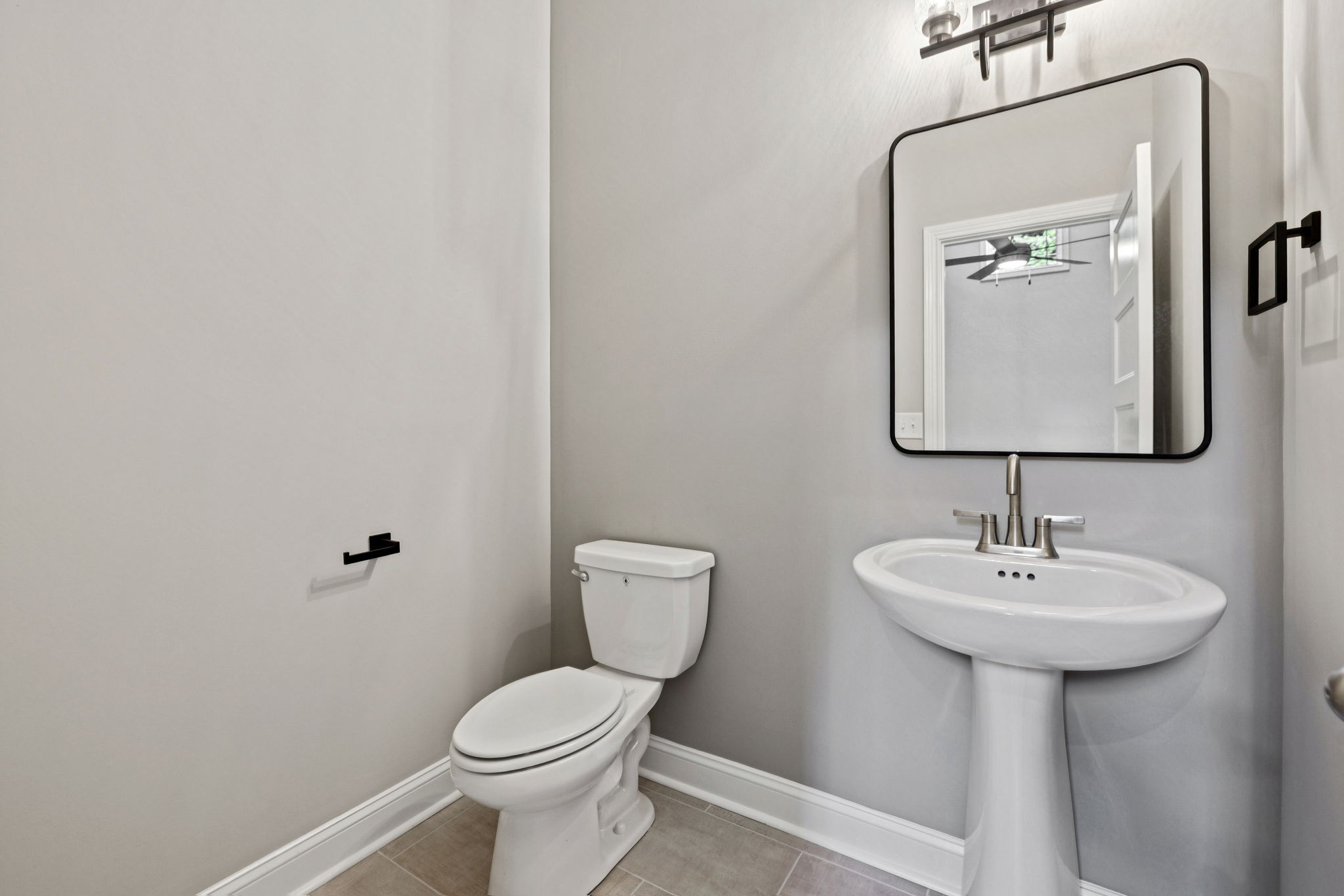 1017 Gholson Road Clarksville, TN 37043 - Photo 43 of 58 a bathroom with a toilet sink and mirror