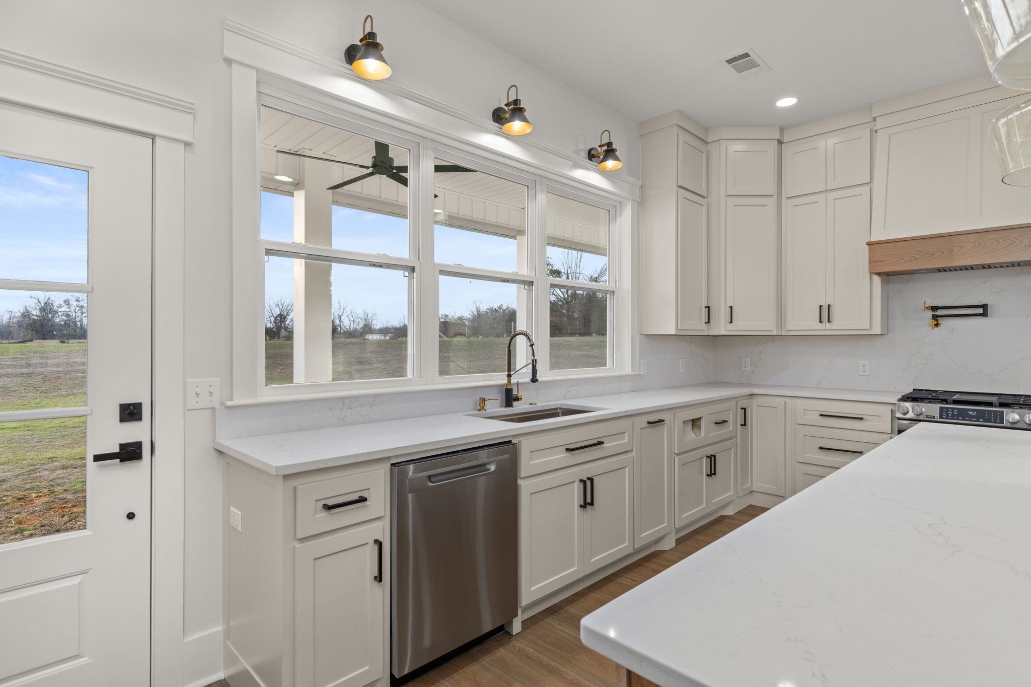 69 County Road 157 Corinth, MS 38834 - Photo 12 of 39 a kitchen with a sink window and cabinets