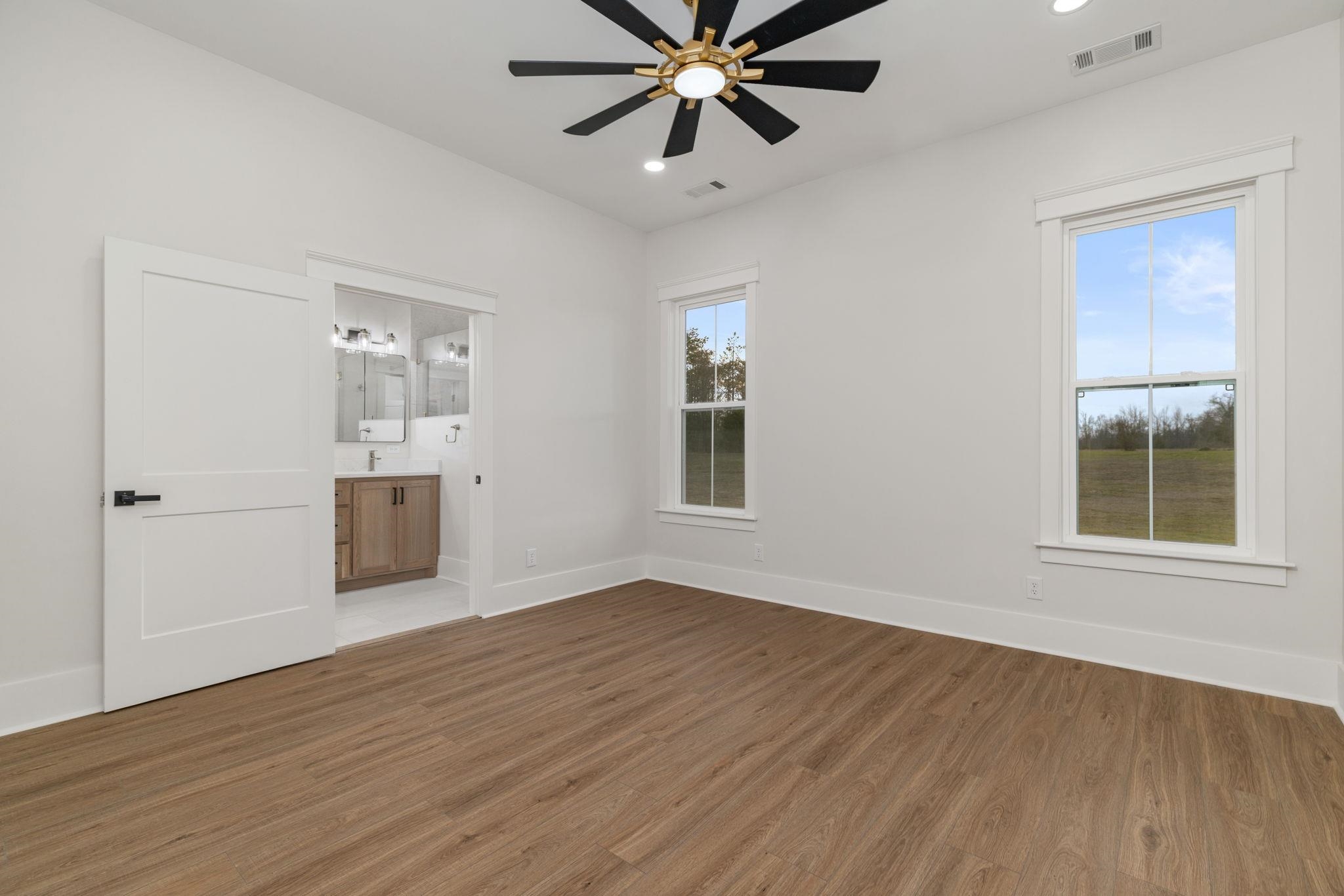 69 County Road 157 Corinth, MS 38834 - Photo 16 of 39 Unfurnished bedroom featuring wood finished floors, recessed lighting, a ceiling fan, and ensuite bathroom