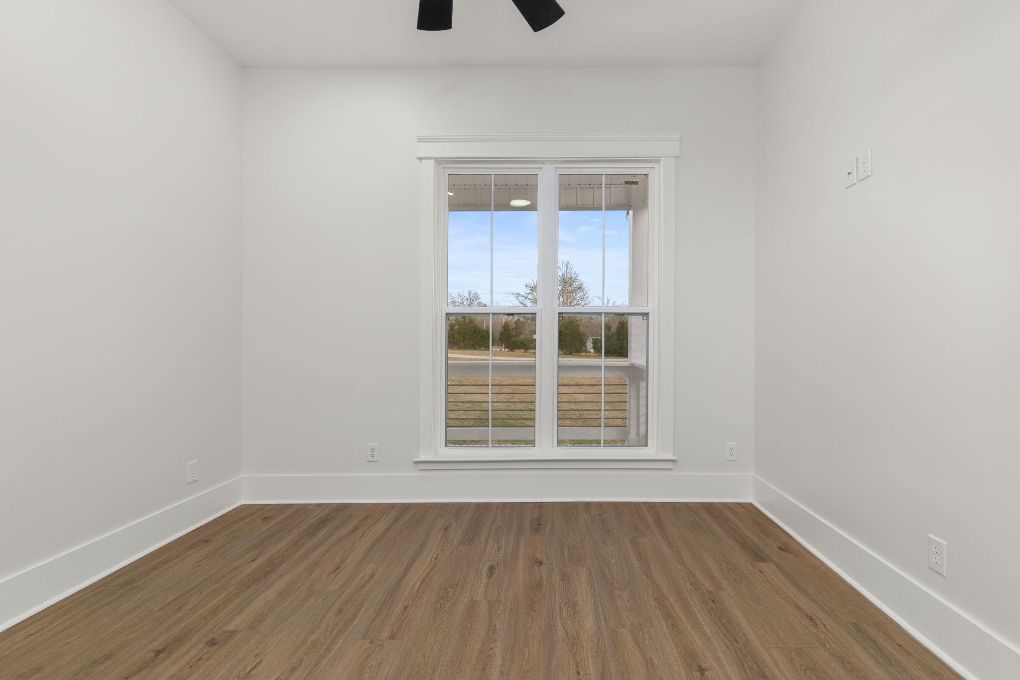 69 County Road 157 Corinth, MS 38834 - Photo 22 of 39 Empty room with dark wood-style floors and a ceiling fan