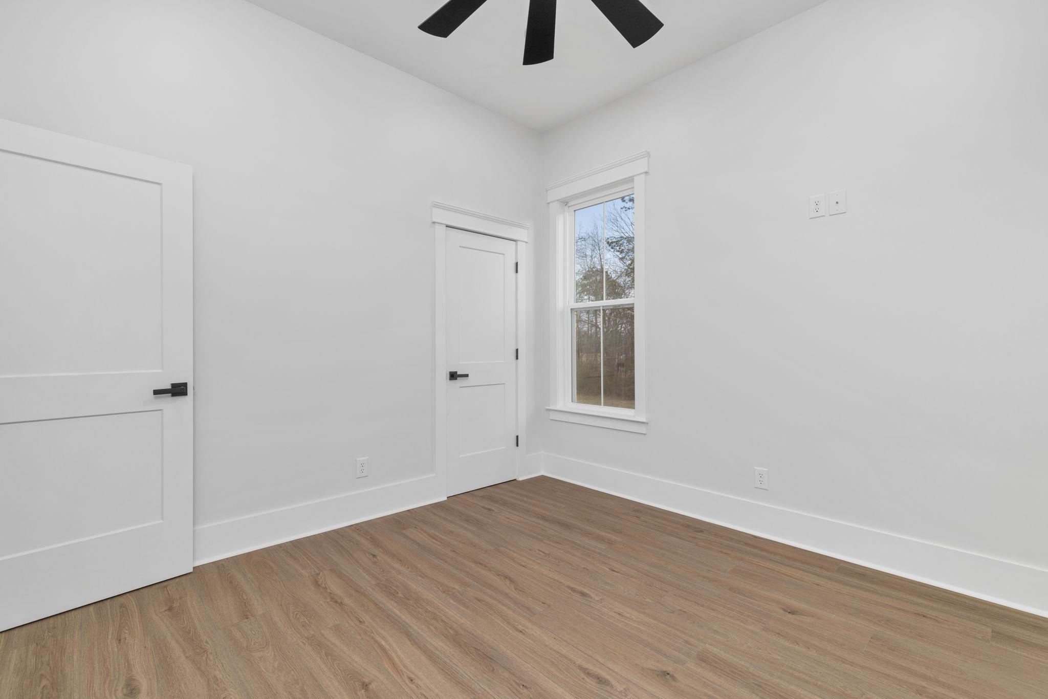 69 County Road 157 Corinth, MS 38834 - Photo 25 of 39 Unfurnished bedroom with light wood finished floors, ceiling fan, and a closet